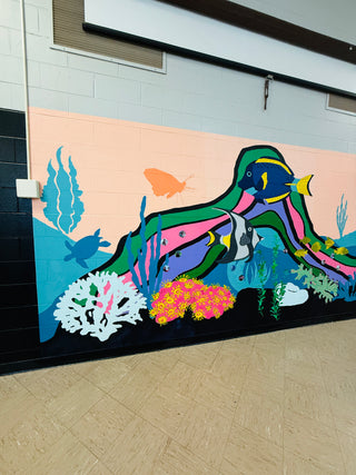Colorful underwater scene mural on a wall with fish, coral, and plants by New Jersey mural artist Chanelle René located at Vineland High School Tanner Building.