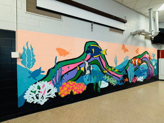 Colorful underwater-themed mural on a wall with fish and coral by artist Chanelle René located at Vineland High School in New Jersey.